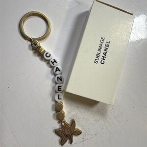 GWP- Sublimage Beaute Gold and White Key Holder with Floral Charm